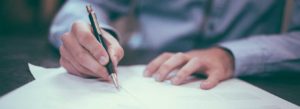 man writing a claim